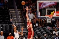Mikal Bridges #25 of the Phoenix Suns shoots past JaVale McGee.